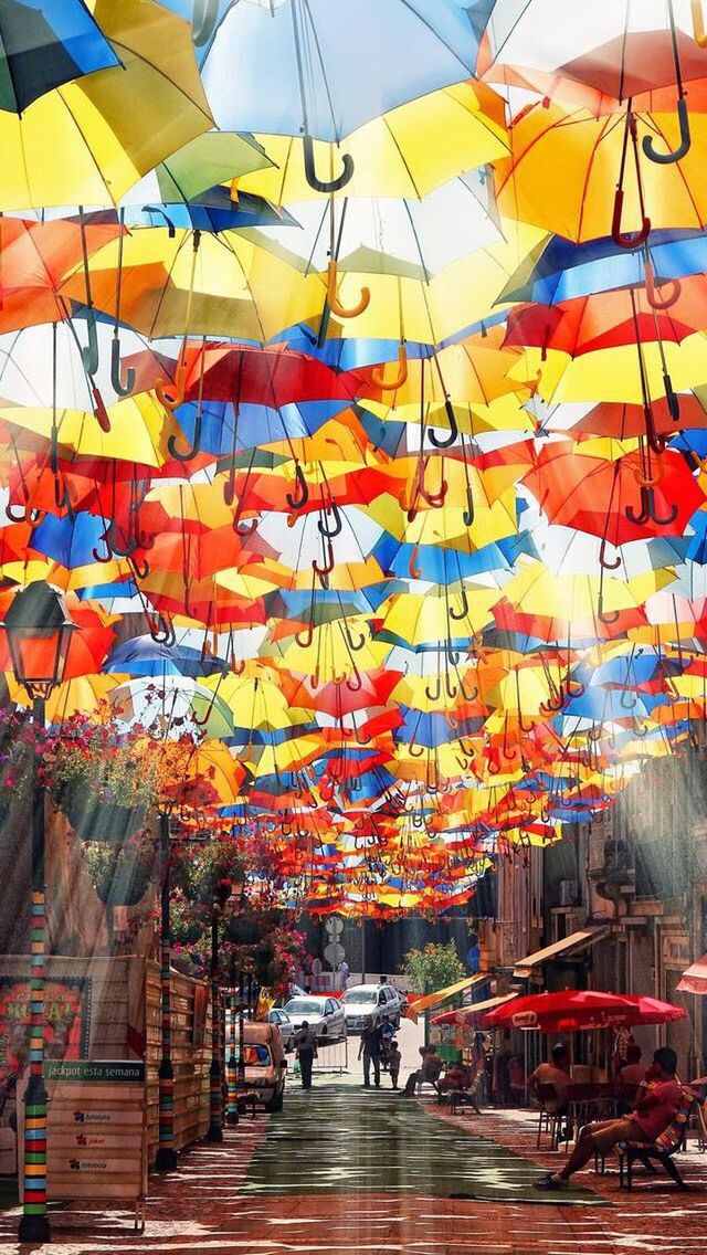 MULTI COLORED FLAGS HANGING ON STREET