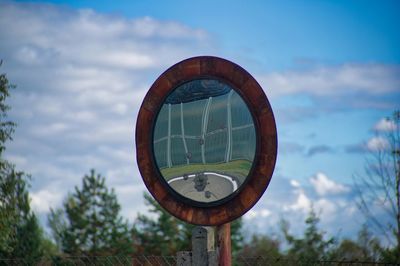 Low angle view of clock against sky