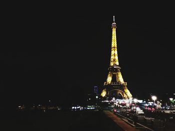 Illuminated buildings against sky at night