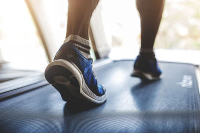 Low section of person running on treadmill