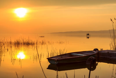 Boats in marina at sunset