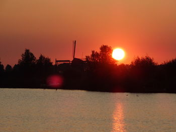 Scenic view of lake against romantic sky at sunset
