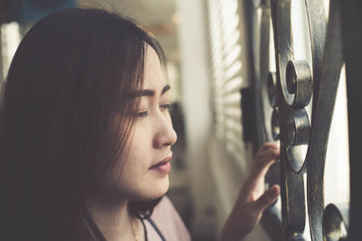 Young woman looking away at home