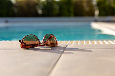 Close-up of sunglasses on swimming pool
