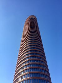 Low angle view of modern building against clear blue sky