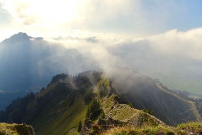 Scenic view of mountains against cloudy sky