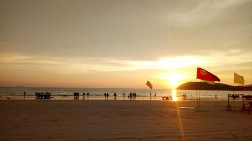 Scenic view of beach against sky during sunset