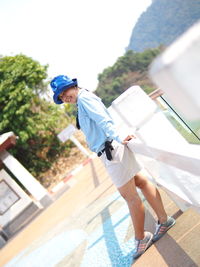 Side view of boy holding umbrella