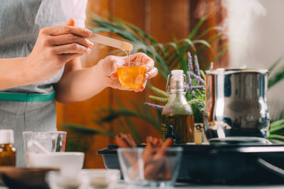 Woman making homemade soap with honey