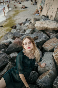 Young woman sitting on rock