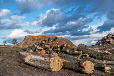 Stack of rocks on land against sky