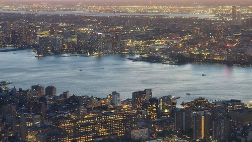 High angle view of illuminated city lit at night new york river
