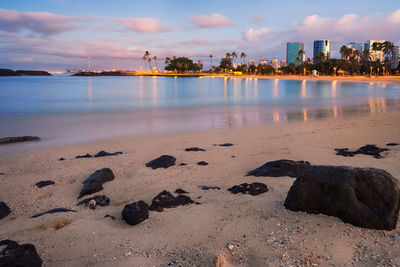 Scenic view of beach against sky during sunset