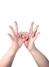 Close-up of hands over white background