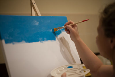 Midsection of woman painting on table