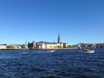 View of buildings at waterfront against clear sky