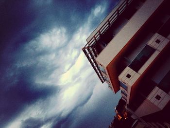 Low angle view of building against cloudy sky