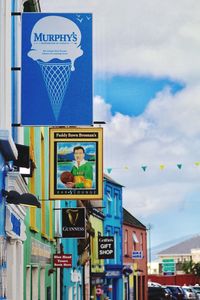 Road sign against sky in city