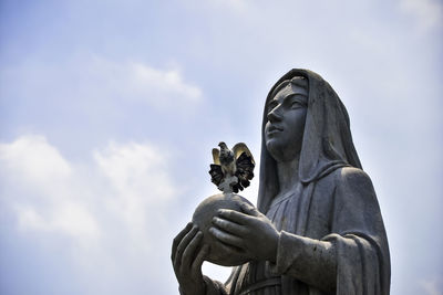 Low angle view of statue against sky