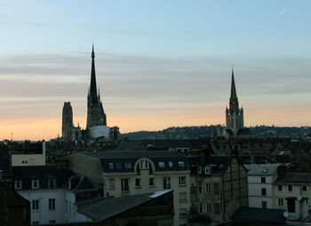 Buildings against sky at sunset