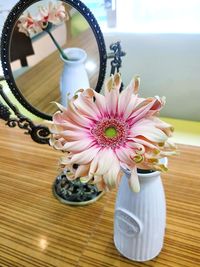 Close-up of pink flower vase on table