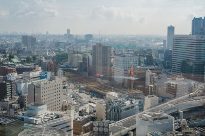 High angle view of buildings in city against sky