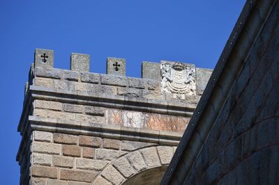 Low angle view of historical building against blue sky