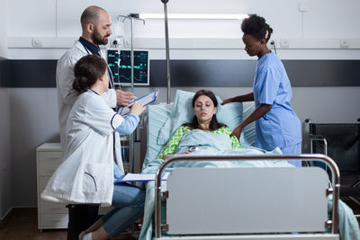 Female doctor examining patient in hospital