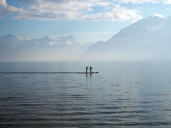 People paddleboarding in lake geneva