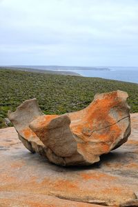 View of rock on beach against sky