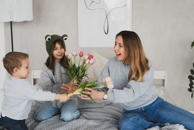 Happy family sitting on sofa at home