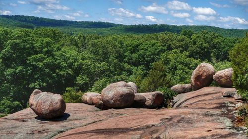 View of rocks on landscape against sky