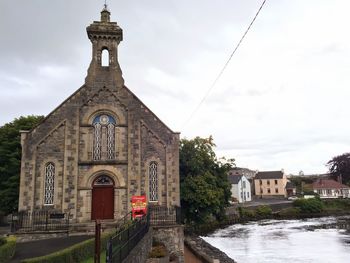 Church by building against sky