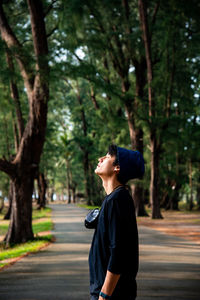 Side view of man standing on road