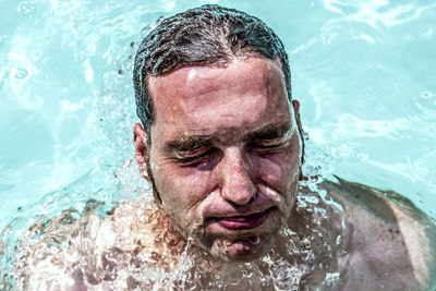 Close-up of man swimming in pool