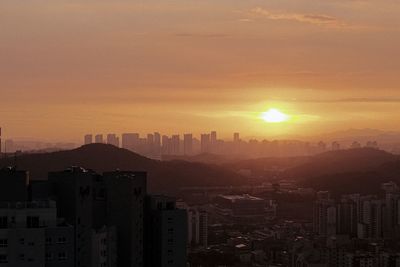 City against sky during sunset