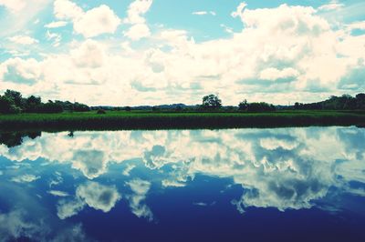 Scenic view of lake against cloudy sky