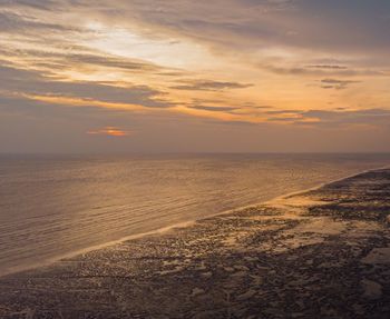 Scenic view of beach against sky during sunset