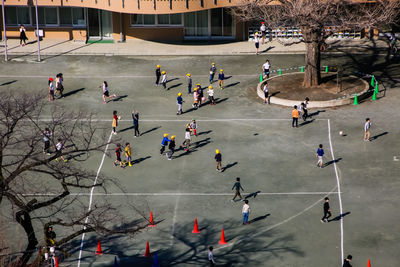 High angle view of people playing on street in city