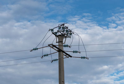 Low angle view of electricity pylon against sky