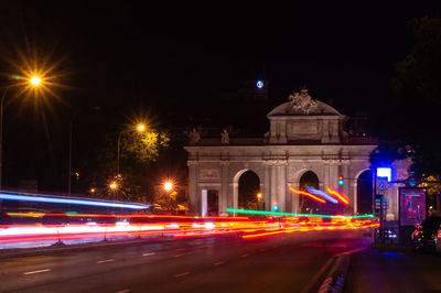 Illuminated light trails on road at night