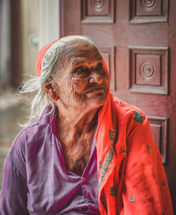 Close-up of senior woman looking away at doorway