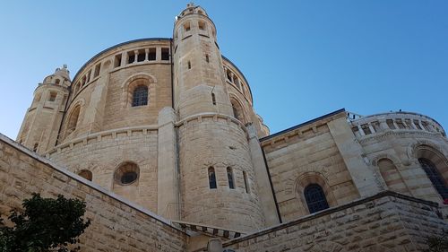 Low angle view of historic building against blue sky