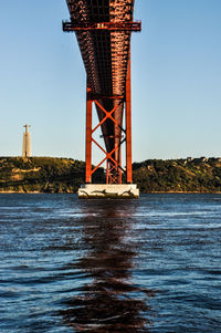 Tower in sea against clear sky