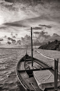 Sailboat on sea shore against sky