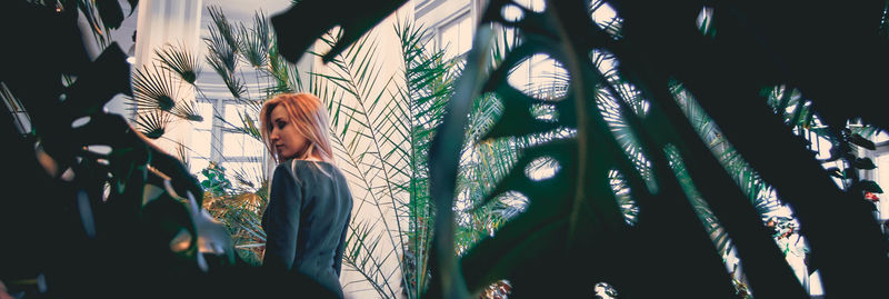 Rear view of woman seen through leaves