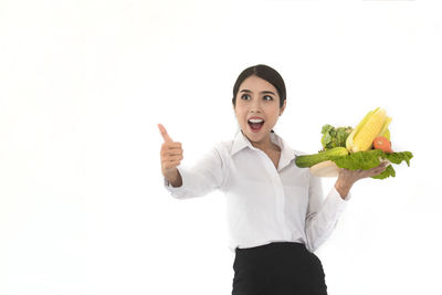 Portrait of a smiling young woman over white background