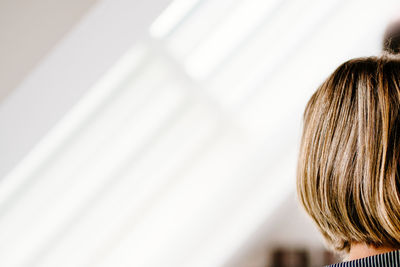 Close-up rear view of cropped woman with blonde hair