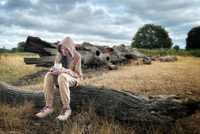 Young woman sitting on field