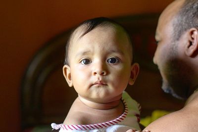 Father holding cute baby girl